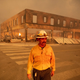 Battalion Chief Sergio Mora looks on as the Dixie fire burns through downtown Greenville, California on Aug. 4, 2021.